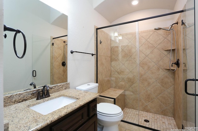 bathroom featuring vanity, toilet, and walk in shower