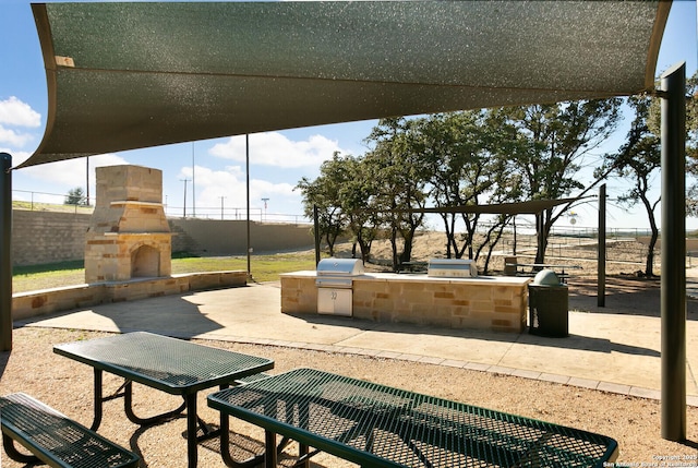 view of community with an outdoor kitchen and a patio area