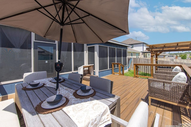 deck featuring a sunroom and a pergola