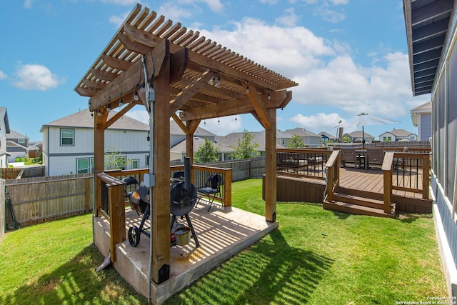 wooden deck featuring a yard and a pergola