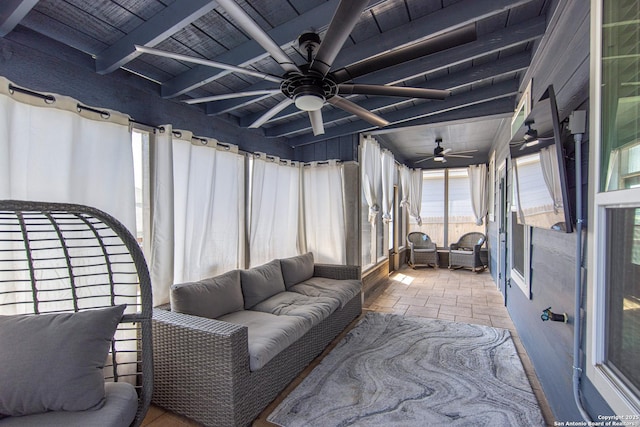 sunroom with beamed ceiling and ceiling fan