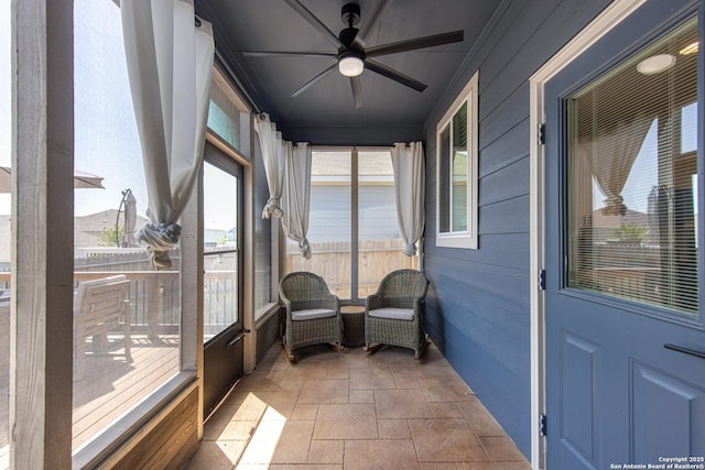 sunroom featuring plenty of natural light and ceiling fan