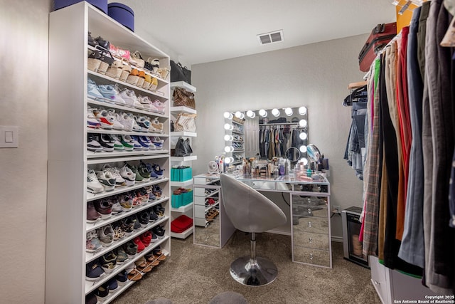 spacious closet with carpet flooring