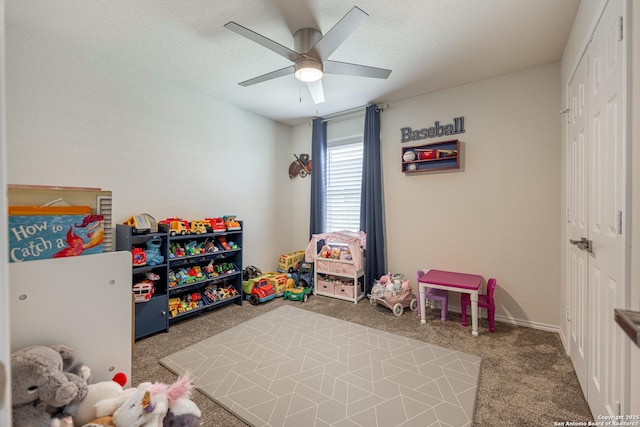 rec room featuring ceiling fan and carpet