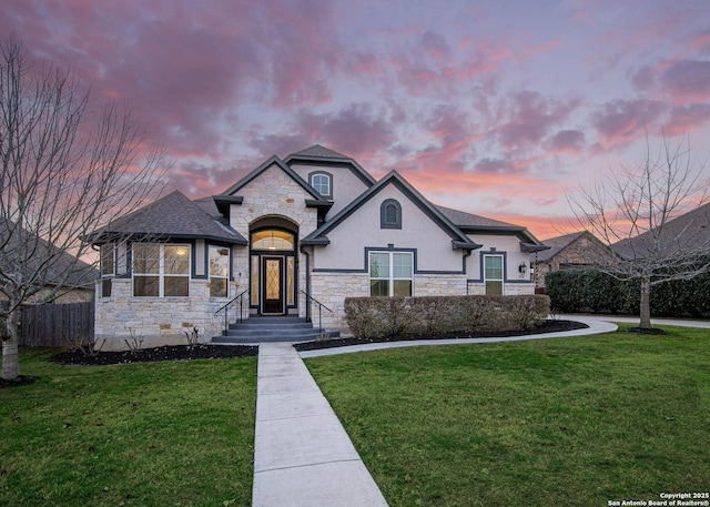 french provincial home with a lawn