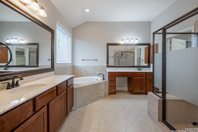 bathroom with lofted ceiling, vanity, tile patterned floors, and independent shower and bath