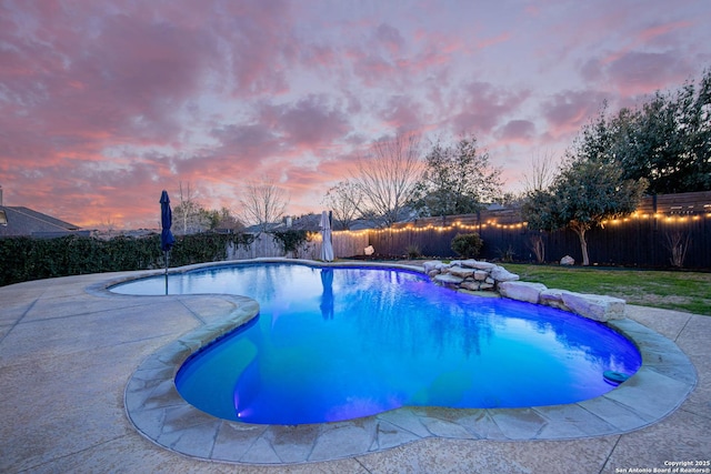 view of pool at dusk