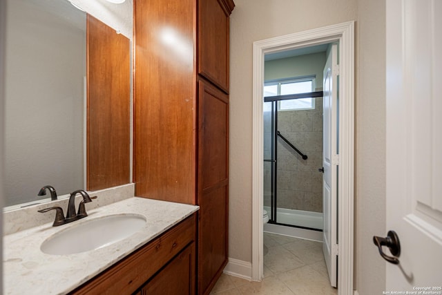 bathroom with vanity, a shower with shower door, and tile patterned flooring