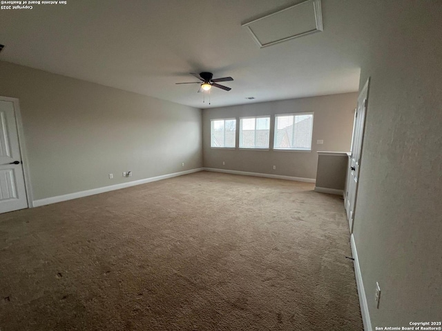 carpeted spare room with ceiling fan