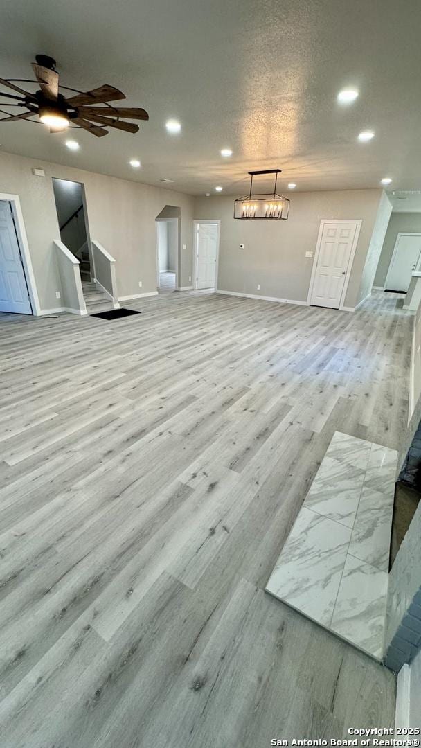 living room featuring ceiling fan and light wood-type flooring