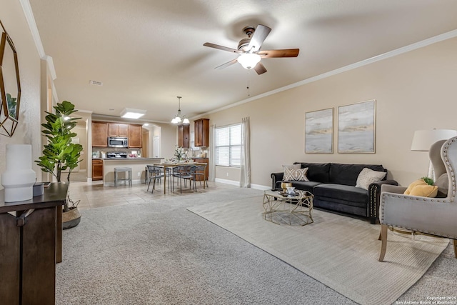 living room with light colored carpet, ornamental molding, and ceiling fan with notable chandelier