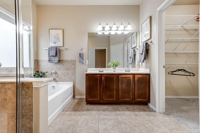 bathroom with vanity, tile patterned flooring, and a tub