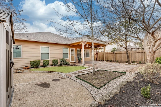 back of property with ceiling fan, a patio area, and a lawn