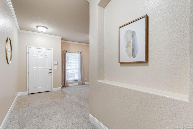 hallway featuring light colored carpet, ornamental molding, and a textured ceiling