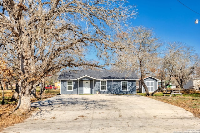 ranch-style home featuring a storage shed