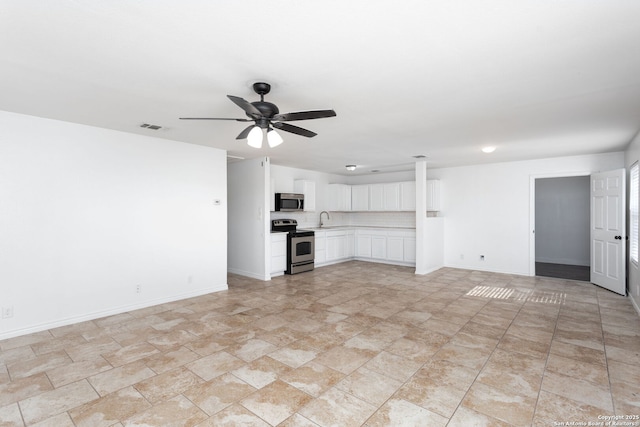 unfurnished living room featuring sink and ceiling fan