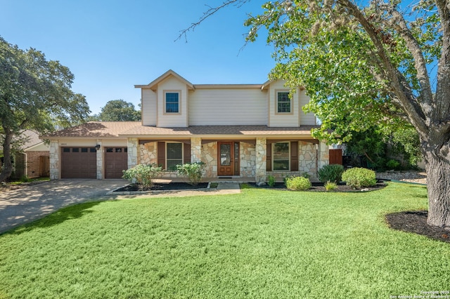 view of front facade featuring a garage, a front yard, and a porch