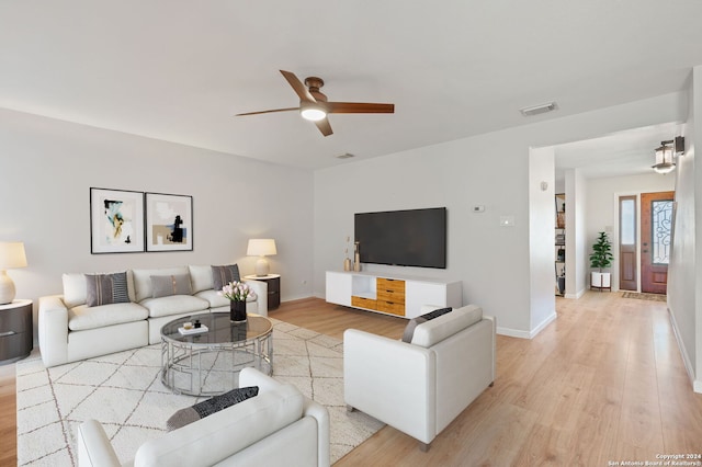 living room with ceiling fan and light wood-type flooring