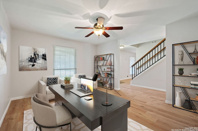 home office featuring light hardwood / wood-style floors and ceiling fan