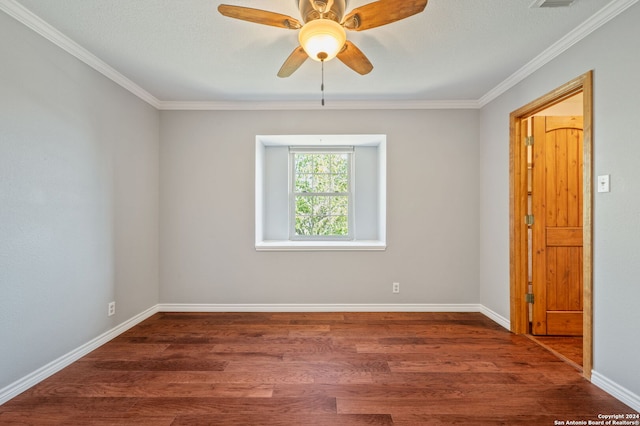 spare room featuring crown molding, dark hardwood / wood-style floors, and ceiling fan