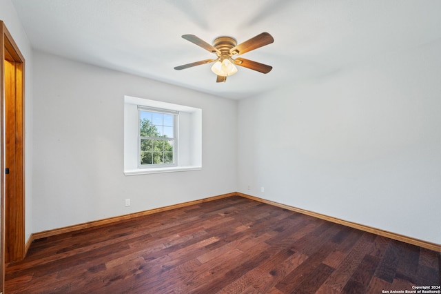 empty room featuring dark wood-type flooring and ceiling fan