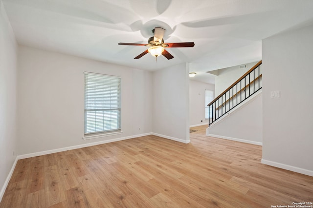 unfurnished room with ceiling fan and light wood-type flooring