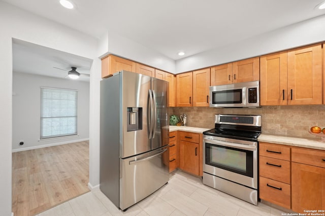 kitchen with backsplash, ceiling fan, and appliances with stainless steel finishes