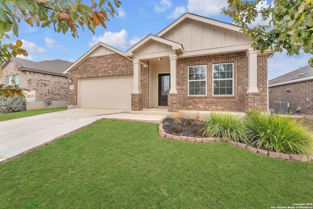 view of front of property with a garage, central AC, and a front lawn