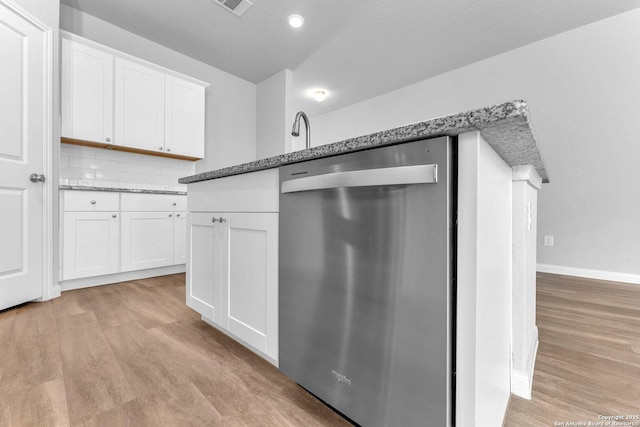 kitchen with stainless steel dishwasher, light hardwood / wood-style flooring, and white cabinets