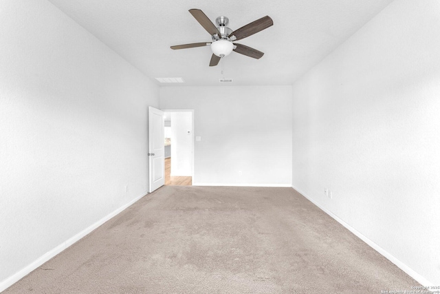 carpeted spare room with ceiling fan