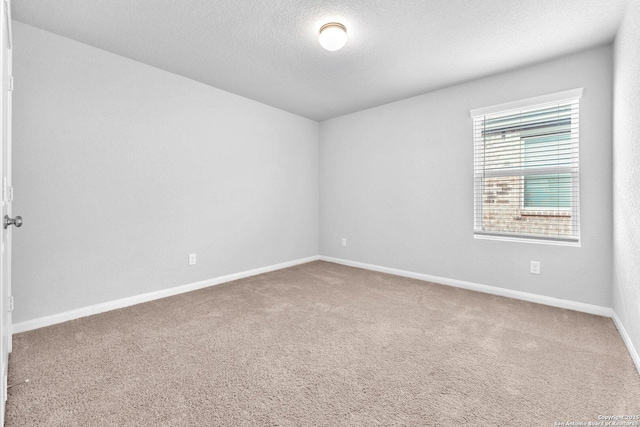 unfurnished room featuring carpet floors and a textured ceiling