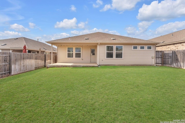 rear view of house featuring a patio and a lawn