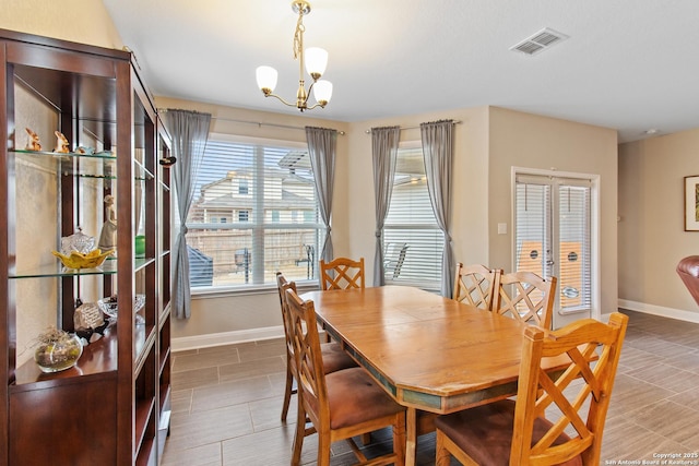 dining area featuring a notable chandelier