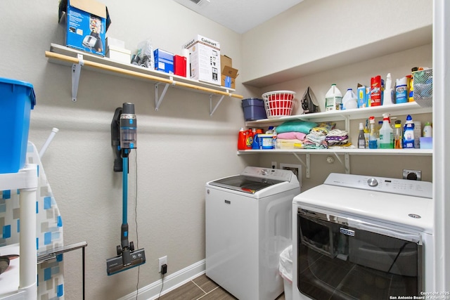 laundry area with wood-type flooring and washing machine and clothes dryer