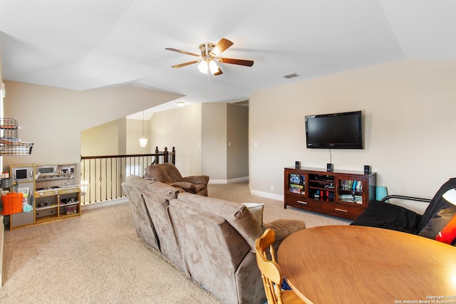 living room featuring vaulted ceiling, light colored carpet, and ceiling fan