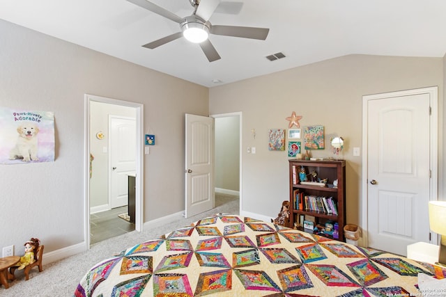 bedroom with ceiling fan, light colored carpet, lofted ceiling, and ensuite bathroom