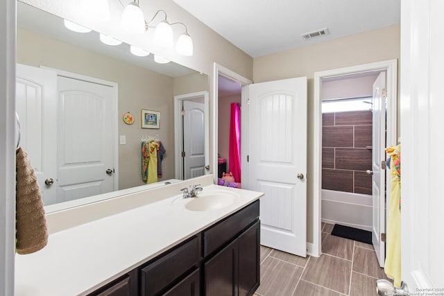 bathroom with vanity and shower / washtub combination