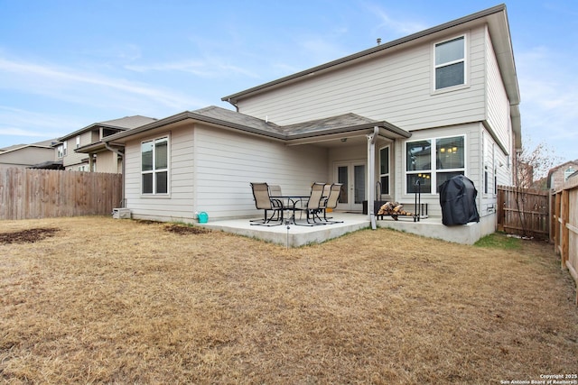 rear view of house featuring a patio and a lawn