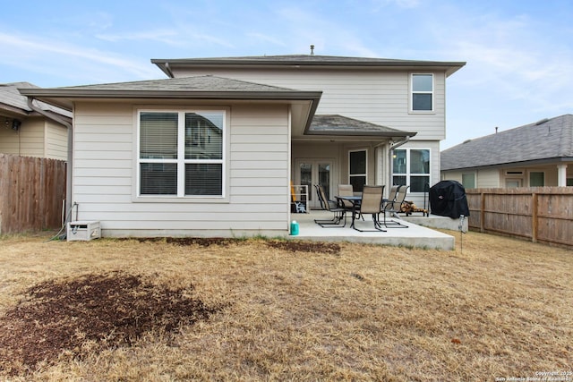 rear view of house with french doors, a yard, and a patio