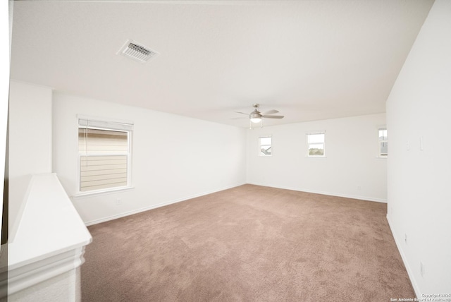 spare room featuring ceiling fan and carpet