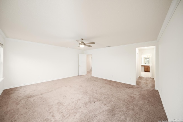 spare room with crown molding, carpet, and ceiling fan