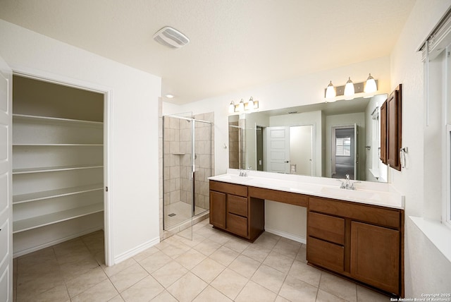 bathroom with vanity, tile patterned floors, and walk in shower