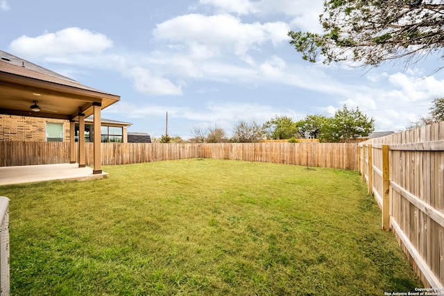 view of yard featuring a patio and ceiling fan