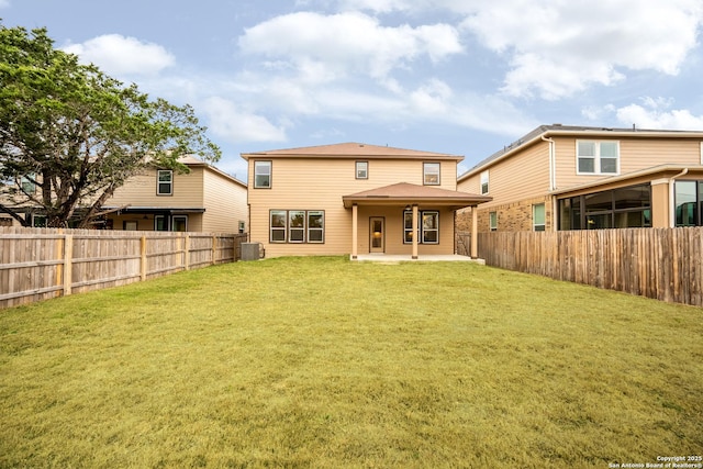 back of house with central AC unit, a yard, and a patio