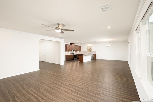 unfurnished living room with dark wood-type flooring, ornamental molding, and ceiling fan with notable chandelier