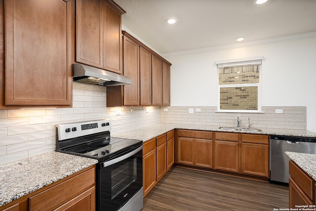 kitchen featuring light stone counters, stainless steel appliances, crown molding, and sink