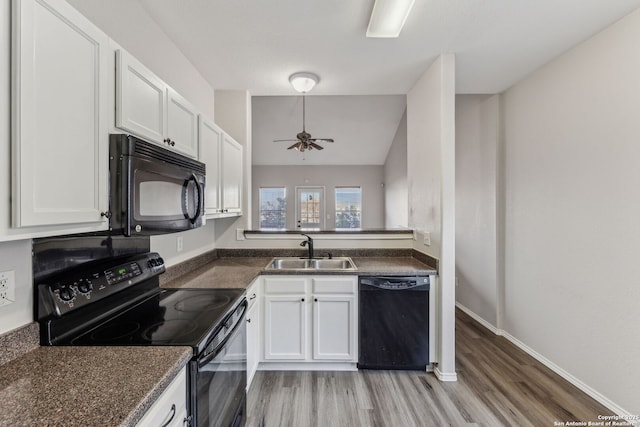 kitchen featuring white cabinetry, sink, and black appliances