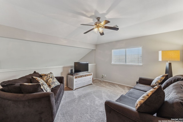 carpeted living room featuring ceiling fan and vaulted ceiling