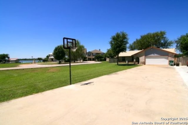 view of basketball court featuring a lawn