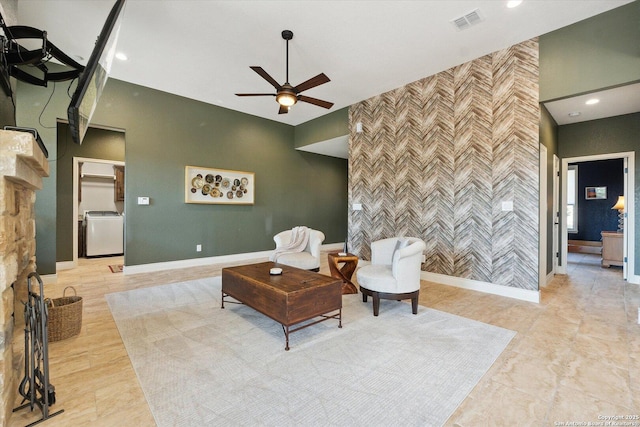 living room featuring ceiling fan and washer / clothes dryer